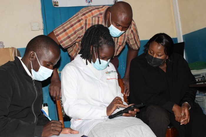 EPAF CCA project staff Cleophas Sore,  Project Officer- Laboratory Commodity Logistician,  and  Dr. Virginia infectious disease Specialist,  perform an On Job Training on EMR to Health Care workers at Ndeiya heal center in Kiambu County  