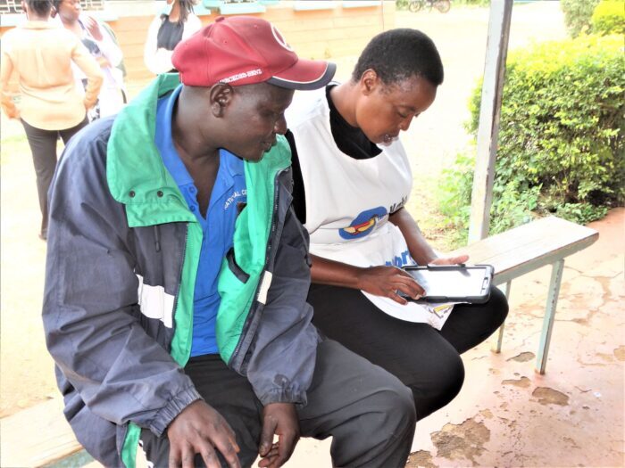 Rahab Ndungú a community health volunteer keys patient data into the electronic medical records system at Ngoliba Health Center, one of the project study sites.    