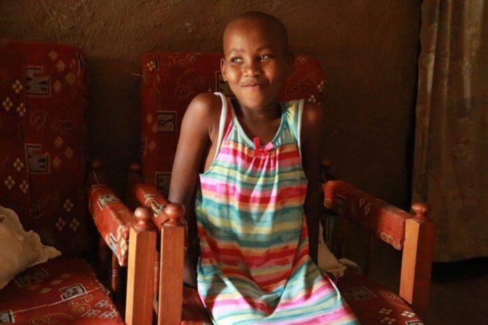 Young girl smiling at camera.