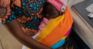 Baby and mother visit clinic in Nigeria.