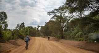 Motorcycles and bicycle on Ugandan road.