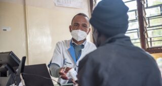 Malawi healthcare worker providing ARVs to client.