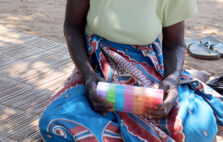 A woman in Mozambique holds pills to treat her tuberculosis.
