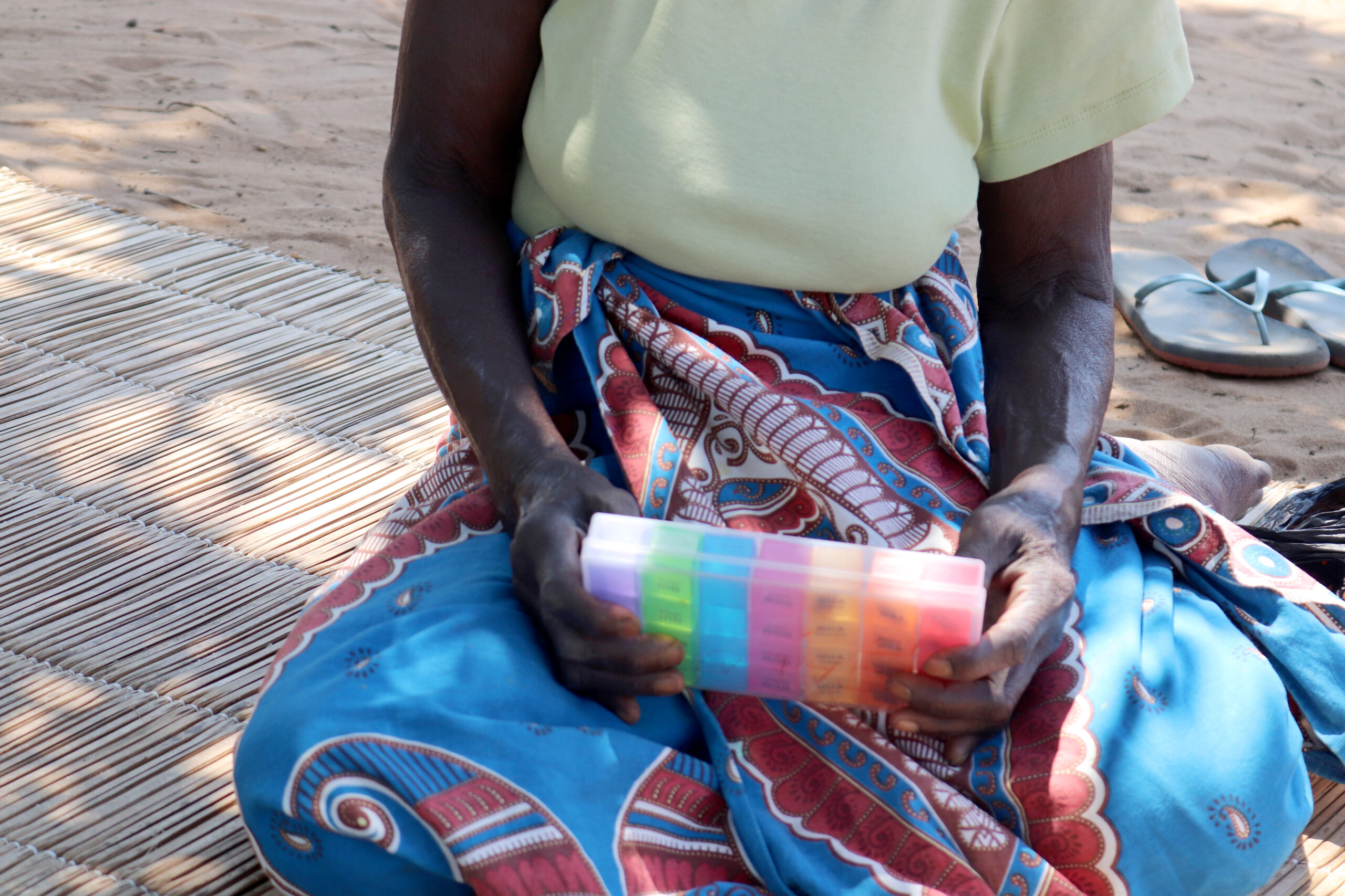 A woman in Mozambique holds pills to treat her tuberculosis.