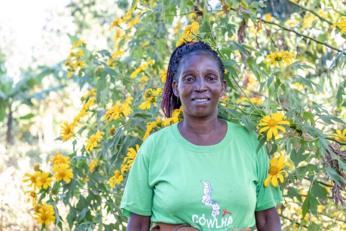 Mentor Mother smiling at the camera wearing a COWLHA shirt.
